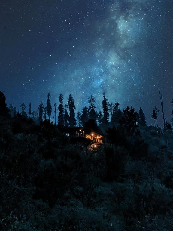 a house on a hill under a starry sky at Roohi in Nagar