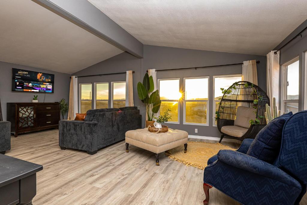 a living room with a couch and chairs and a tv at Mountain Views minutes from casinos and Lake in Bullhead City