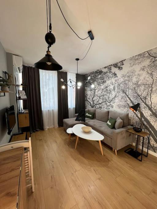 a living room with a couch and a table at Cozy Boutique Apartment in Plovdiv in Plovdiv