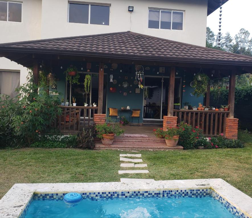 a house with a swimming pool in the yard at Villa Diosa in Jarabacoa