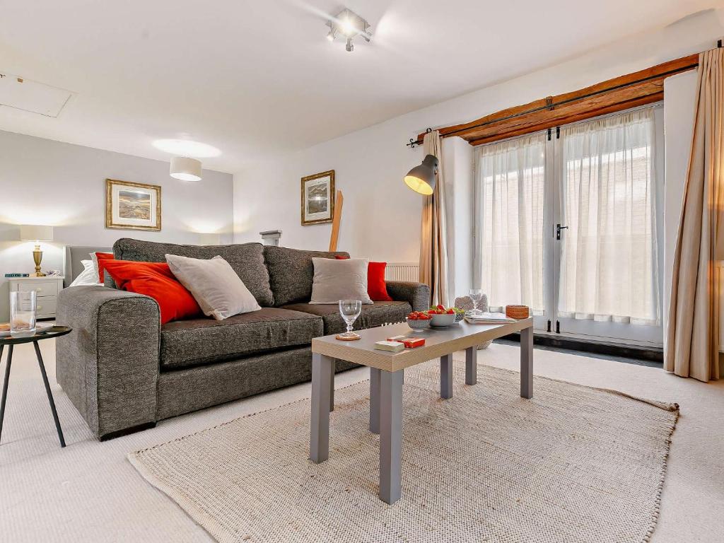 a living room with a couch and a table at 1 Bed in Tavistock HIGHM in Marytavy