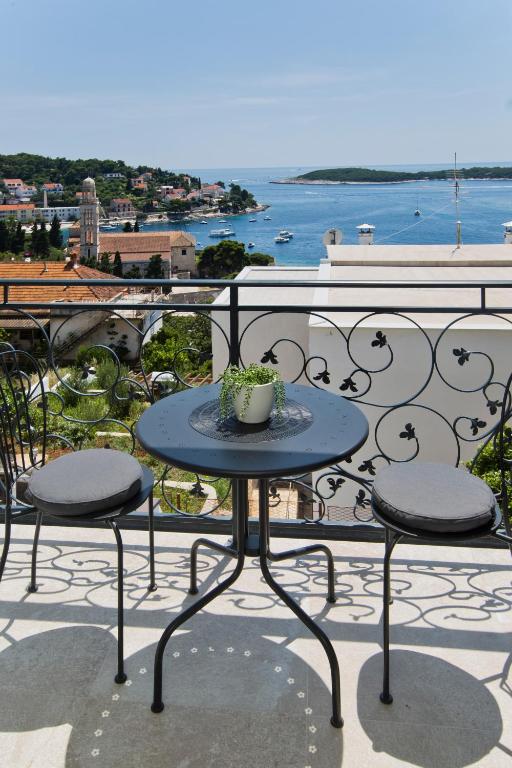 a table with a potted plant on top of a balcony at Villa Milton Luxe Hvar in Hvar