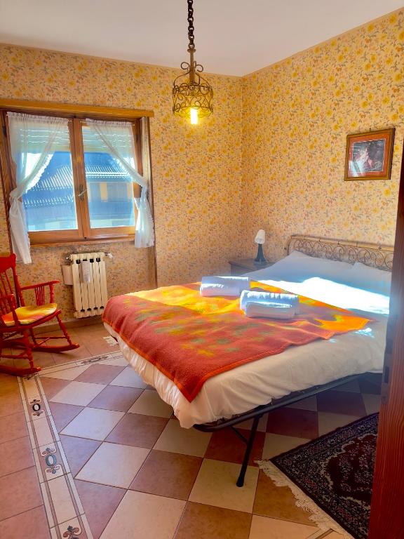 a bedroom with a large bed in a room at Rifugio Tra Le Vette in Bardonecchia