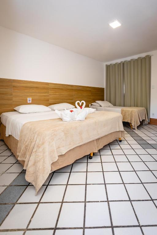 Uma cama ou camas num quarto em Arraial do Sol Beach Hotel