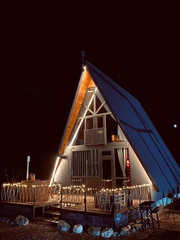 a house with lights on the front at night at Cottage GarShemo Kazbegi in Kazbegi