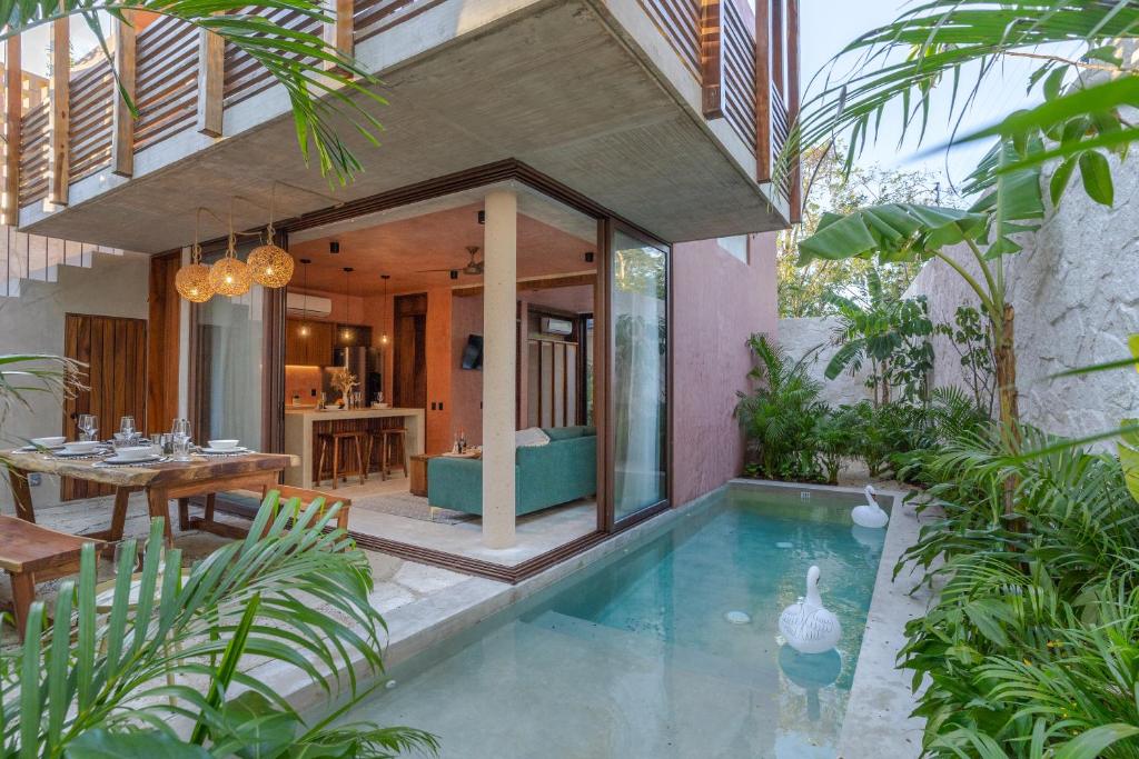 a house with a swimming pool in the middle of a yard at Entorno Tulum - Luxury Villas in Tulum