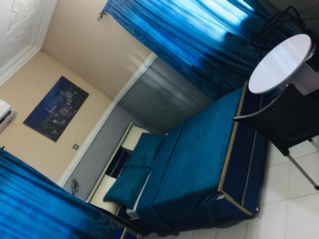 an overhead view of a room with blue curtains at D Light Hotel in Abuja