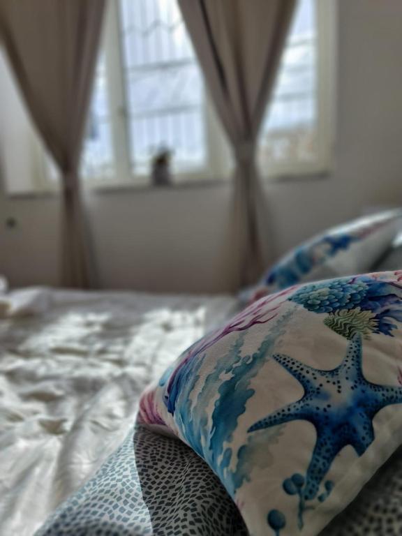 a bed with a pillow on top of it at Casa Gimaga in Pozzuoli