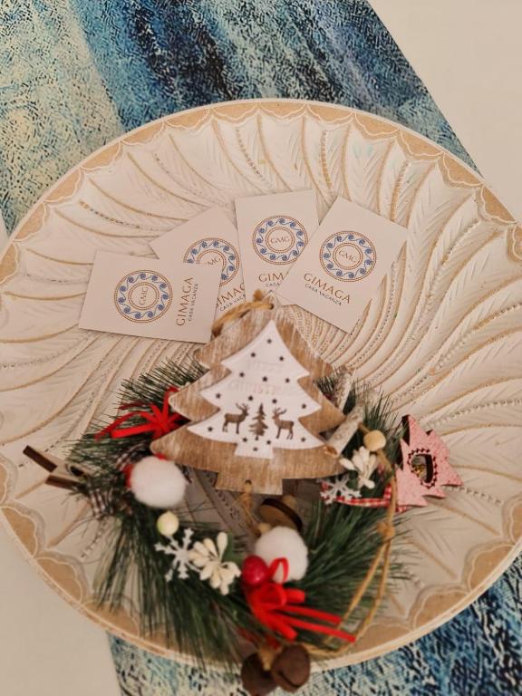 a plate with a christmas decoration on a table at Casa Gimaga in Pozzuoli