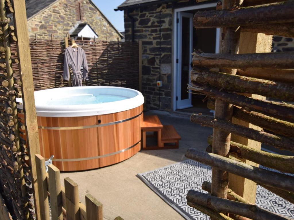 a hot tub on the patio of a house at 1 bed property in Launceston 81332 in Saint Giles on the Heath