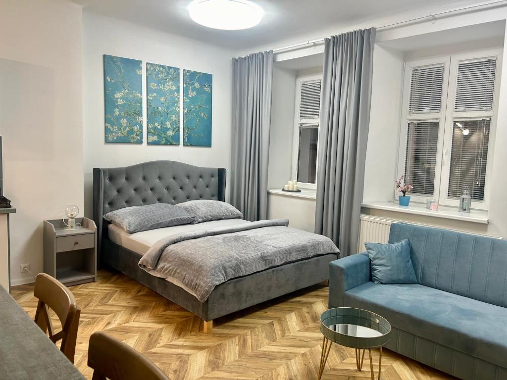 a bedroom with a bed and a couch at Almond Studio Apartment in Bratislava