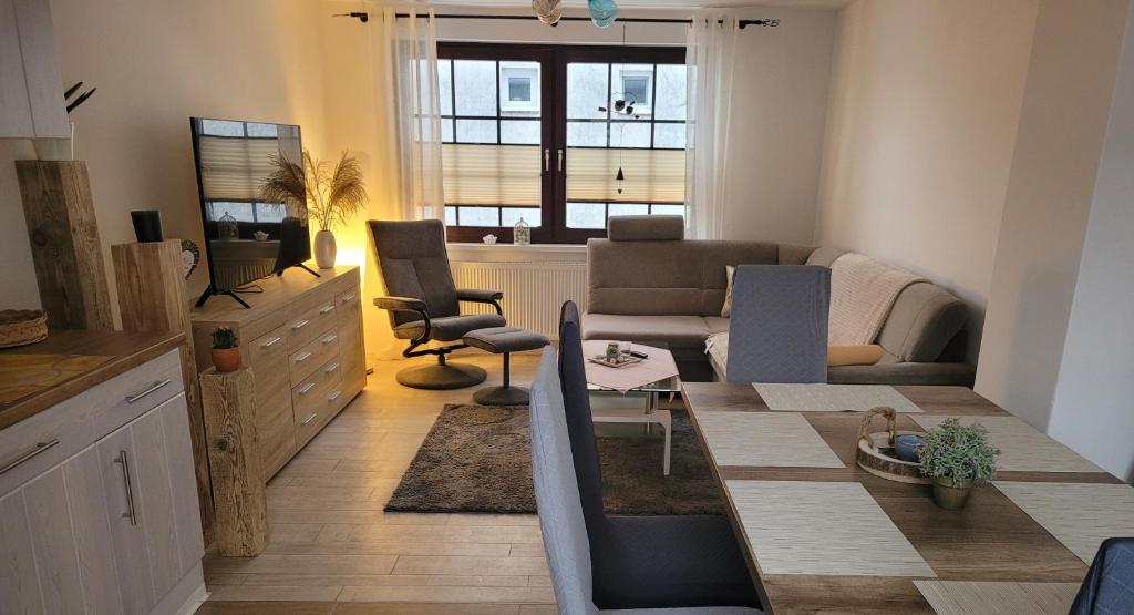 a living room with a couch and a table and chairs at Stadtperle Bad-Sülze in Bad Sülze