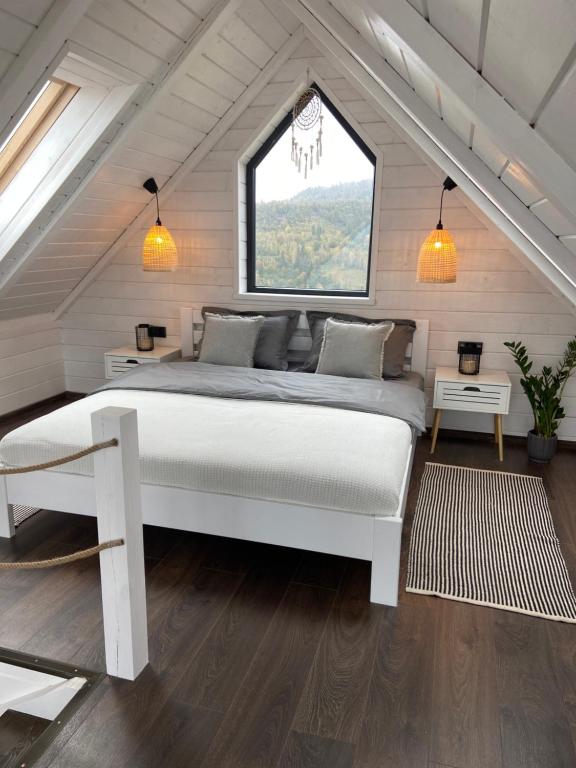 a bedroom with a large bed in a attic at Under_sky_slavske in Slavske