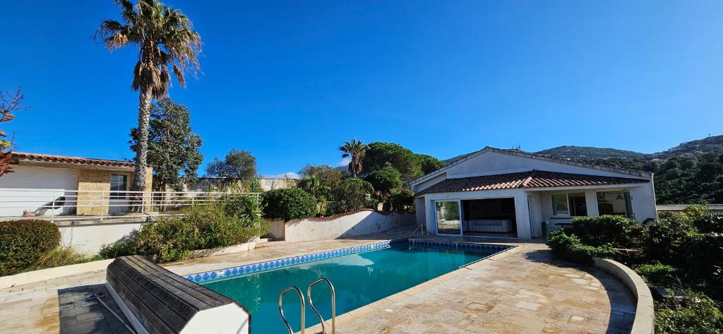 una piscina frente a una casa en Villa de standing Les Amandiers, vue mer & piscine, en Propriano