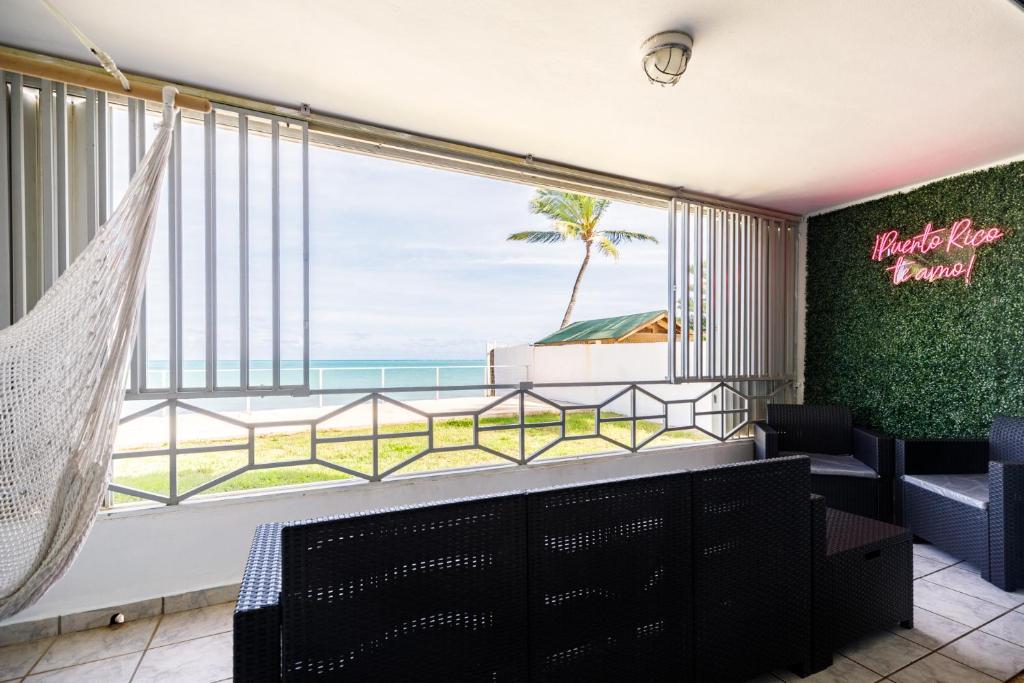 a room with a large window with a view of the ocean at Fortuna Paradise in Luquillo