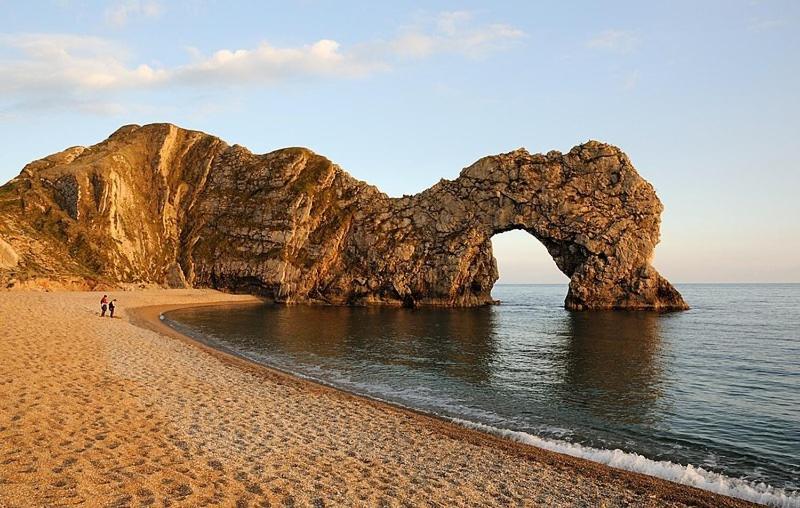 a rock formation in the water on a beach at 2-6 guests Holiday Chalet in Durdle Door in West Lulworth