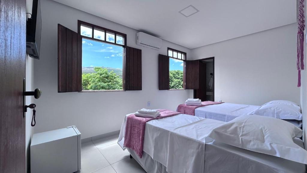Cama ou camas em um quarto em Pousada Estrelar