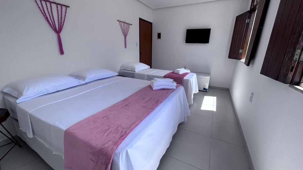 Cama ou camas em um quarto em Pousada Estrelar