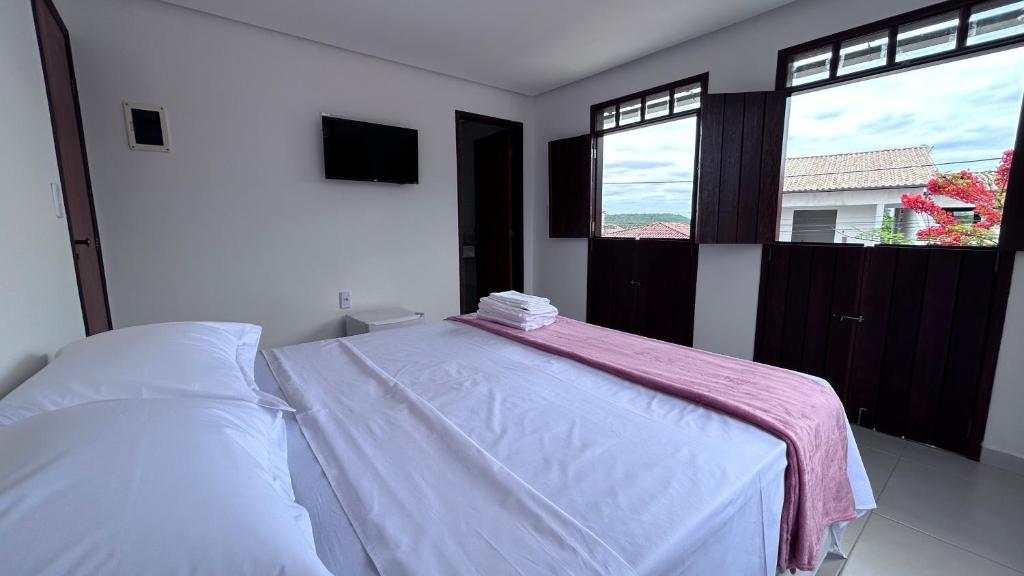 Cama ou camas em um quarto em Pousada Estrelar