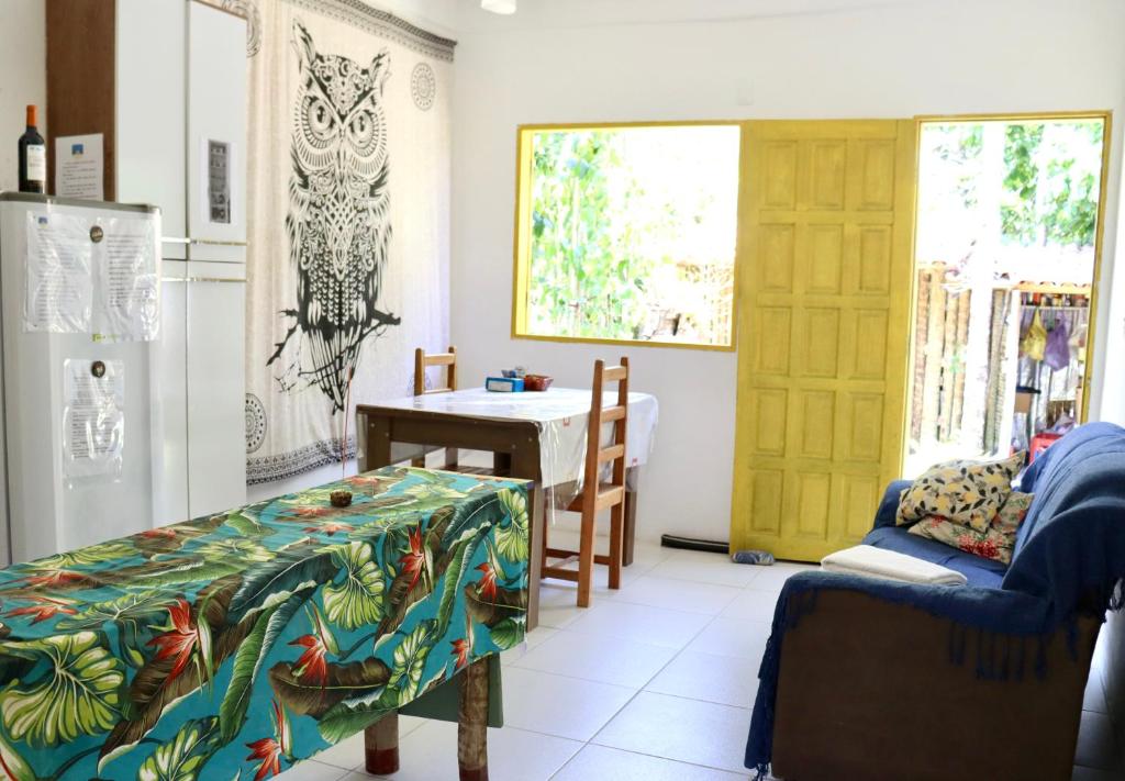 a kitchen with a table and a refrigerator at Res. Orion Praia do Espelho in Praia do Espelho
