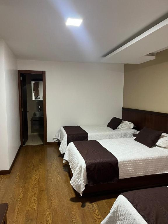 Postel nebo postele na pokoji v ubytování HOSTAL CAMIL