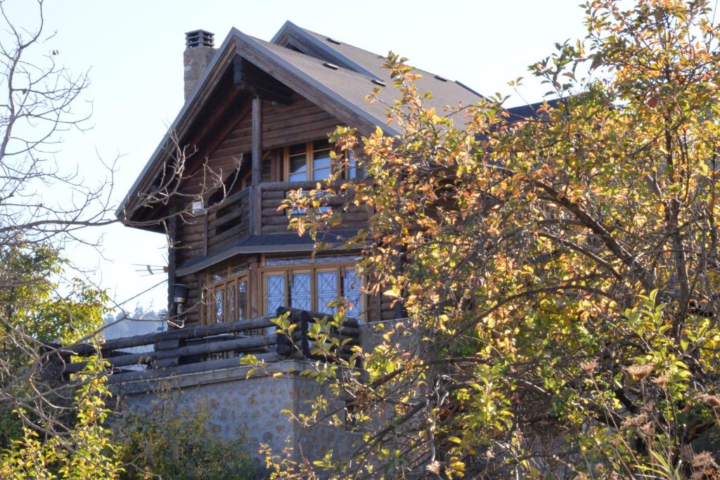 a large wooden house with a porch at Oreias Chalet in Ano Trikala