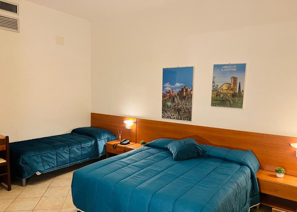 Postel nebo postele na pokoji v ubytování Hotel Vico Alto Siena