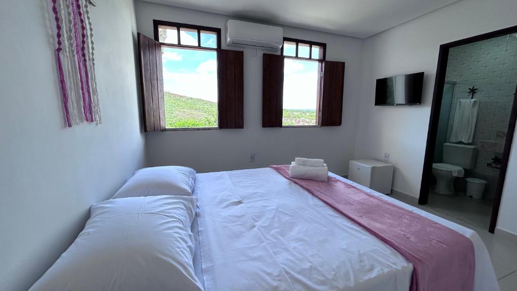 Cama ou camas em um quarto em Pousada Estrelar