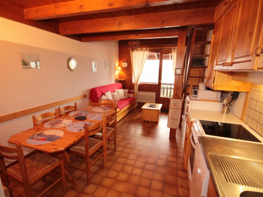 a kitchen and dining room with a table and a couch at Appartement Villard-sur-Doron, 3 pièces, 6 personnes - FR-1-293-328 in Villard-sur-Doron