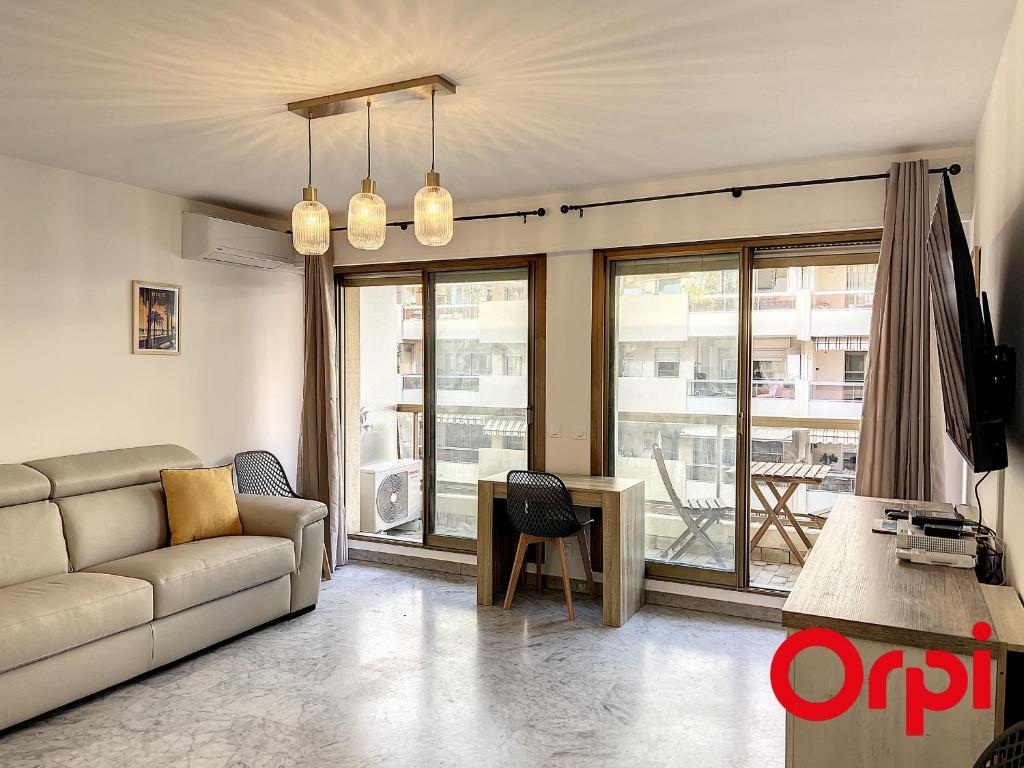 un salon avec un canapé et une table dans l'établissement Appartement climatisé avec terrasse, centre-ville de Menton, à deux pas des plages - FR-1-647-24, à Menton