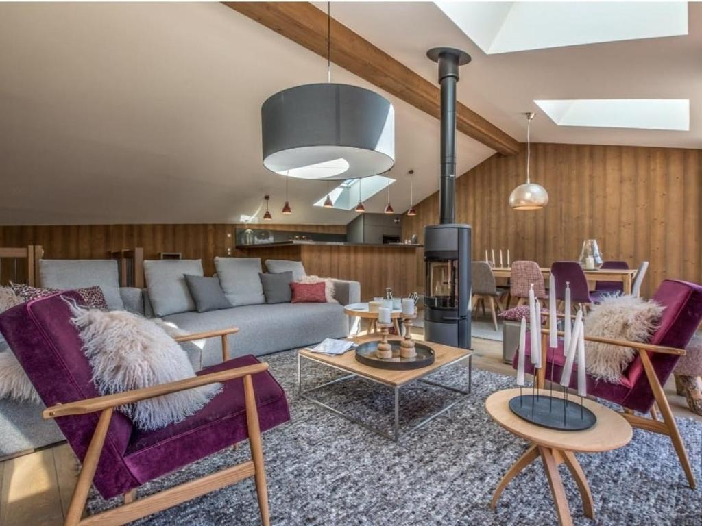a living room with purple chairs and a couch at Maison Courchevel, 5 pièces, 8 personnes - FR-1-772-4 in Courchevel
