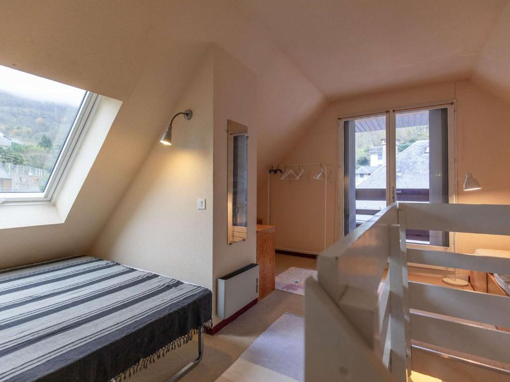 a small room with a bed and a staircase at Appartement Luz-Saint-Sauveur, 1 pièce, 5 personnes - FR-1-402-136 in Luz-Saint-Sauveur