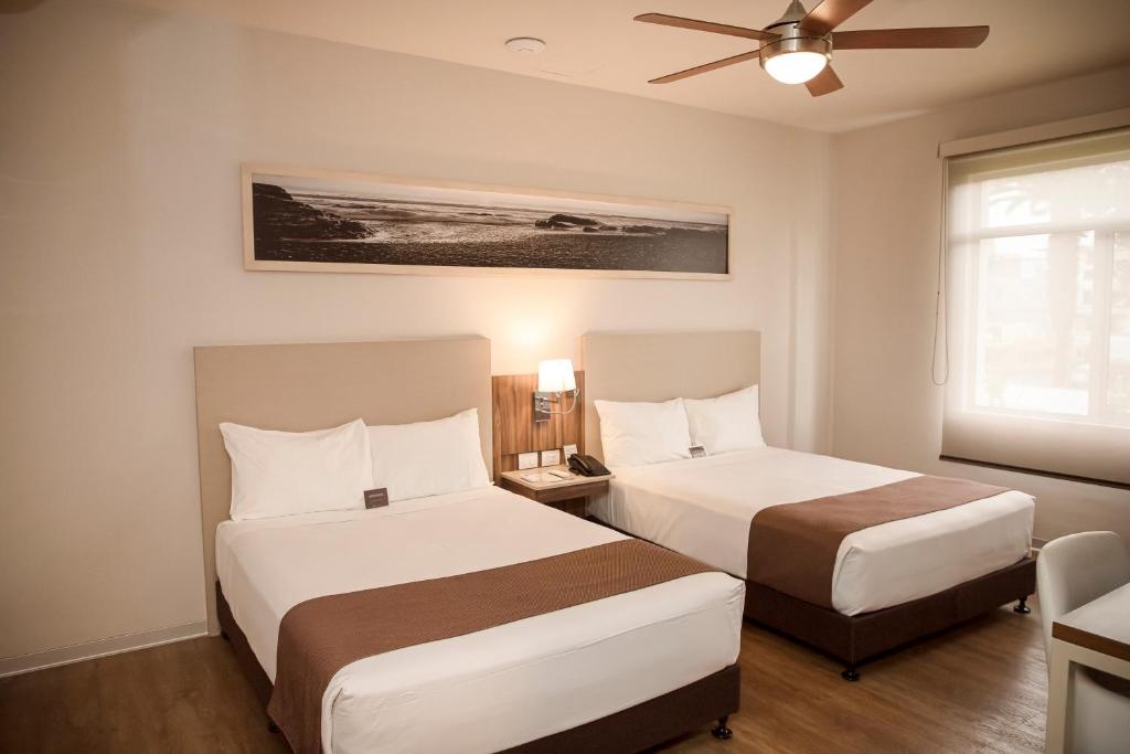 Postel nebo postele na pokoji v ubytování DM Hoteles Tacna