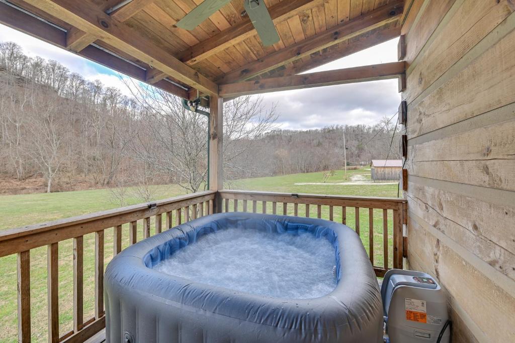 a hot tub on the deck of a cabin at Pet-Friendly Cabin with Hot Tub in Daniel Boone NF in Beattyville