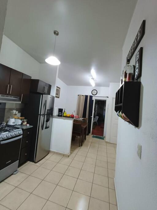 una cocina con electrodomésticos en blanco y negro y una mesa en Descansa como en casa, en San Miguel