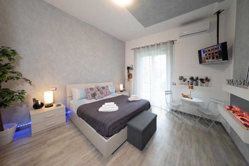 a bedroom with a bed and a desk and a sink at Relax room Apartment in Rome