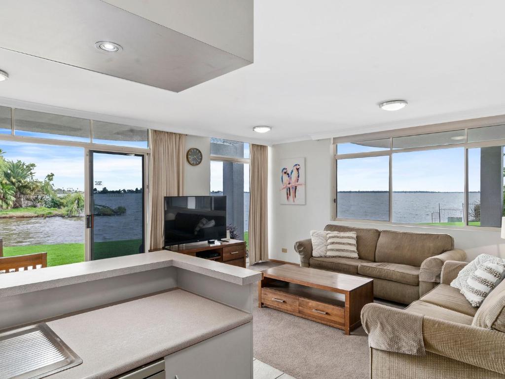 a living room with a couch and a tv at Yarrawonga Lakeside Apartment 41 in Mulwala