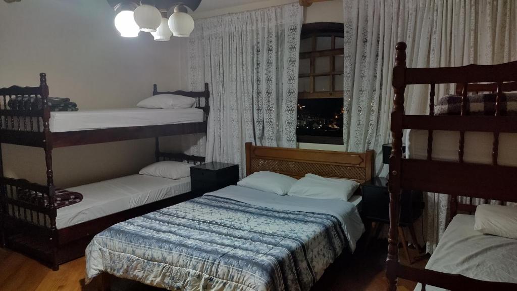 a bedroom with two bunk beds and a window at Oberon in Curitiba