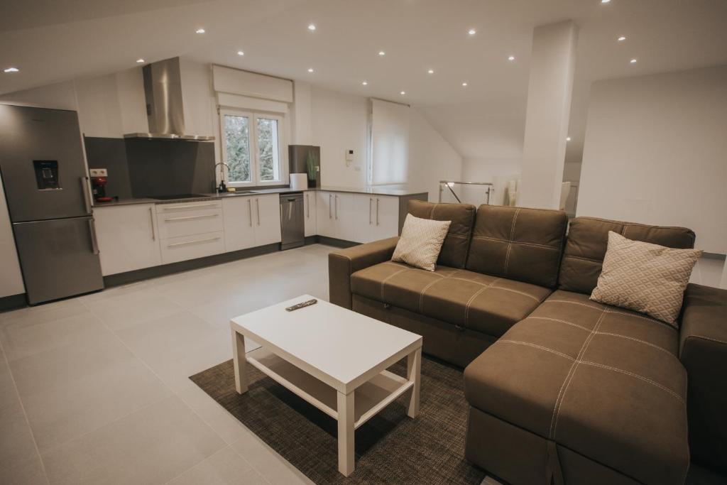 a living room with a couch and a table at Casas del Pedregal apartamento 3 in A Estrada