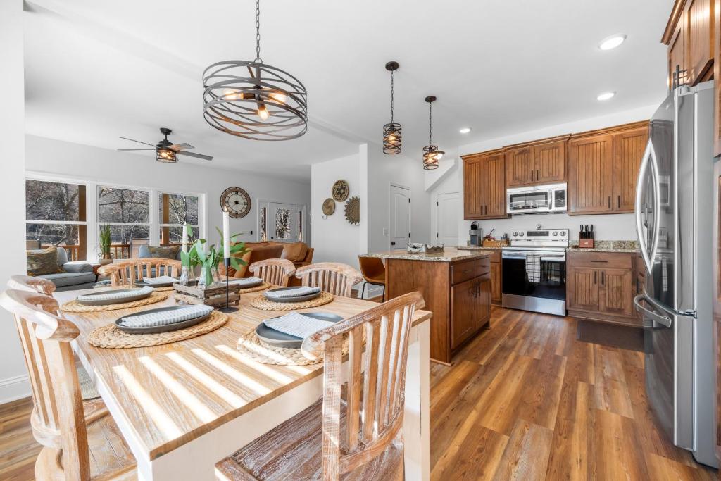 a kitchen and living room with a table and chairs at Charming Murphy House with Deck & River Views! in Murphy