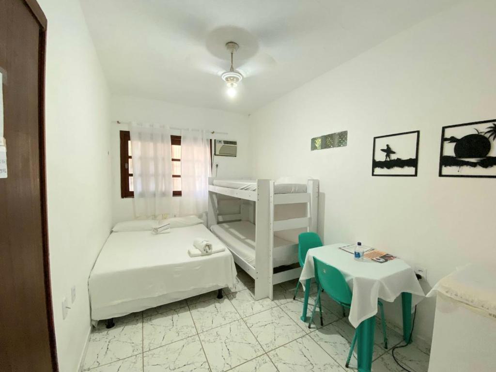 a room with two bunk beds and a table at BEACH HOUSE l in Itacaré