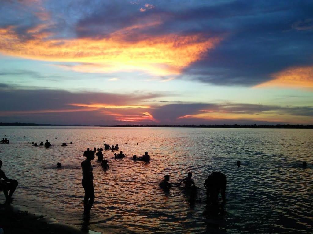 a group of people in the water at sunset at Casa El Sueño in Ituzaingó