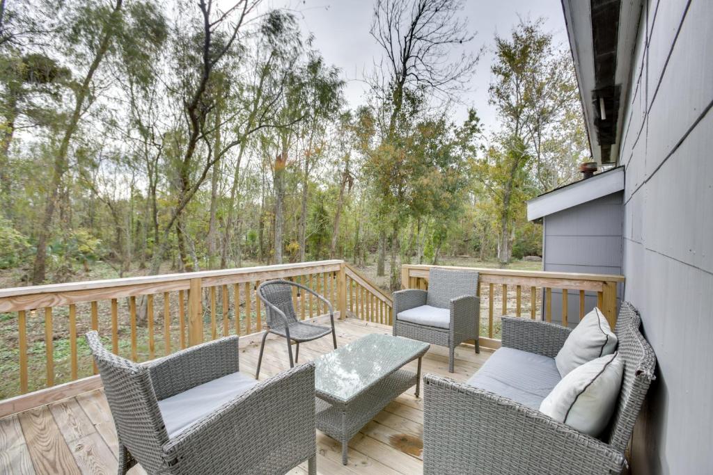 a deck with wicker chairs and a table at Charming Louisiana Getaway with Deck and Yard! in Destrehan
