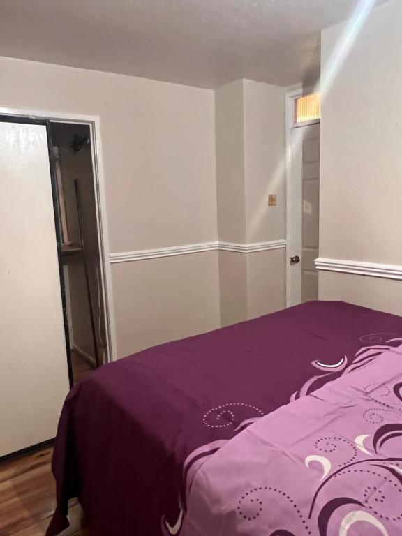 a bedroom with a purple bed in a room at A&G in Thurcaston