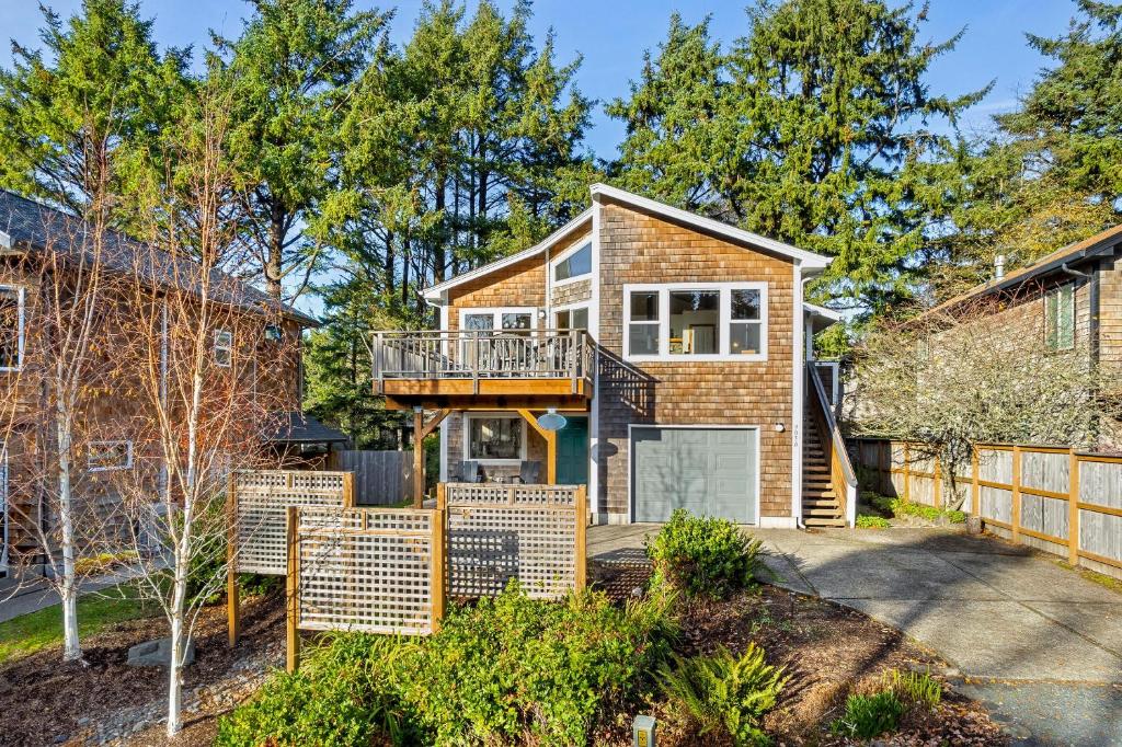 a house with a balcony and a fence at Sand Bucket in Manzanita