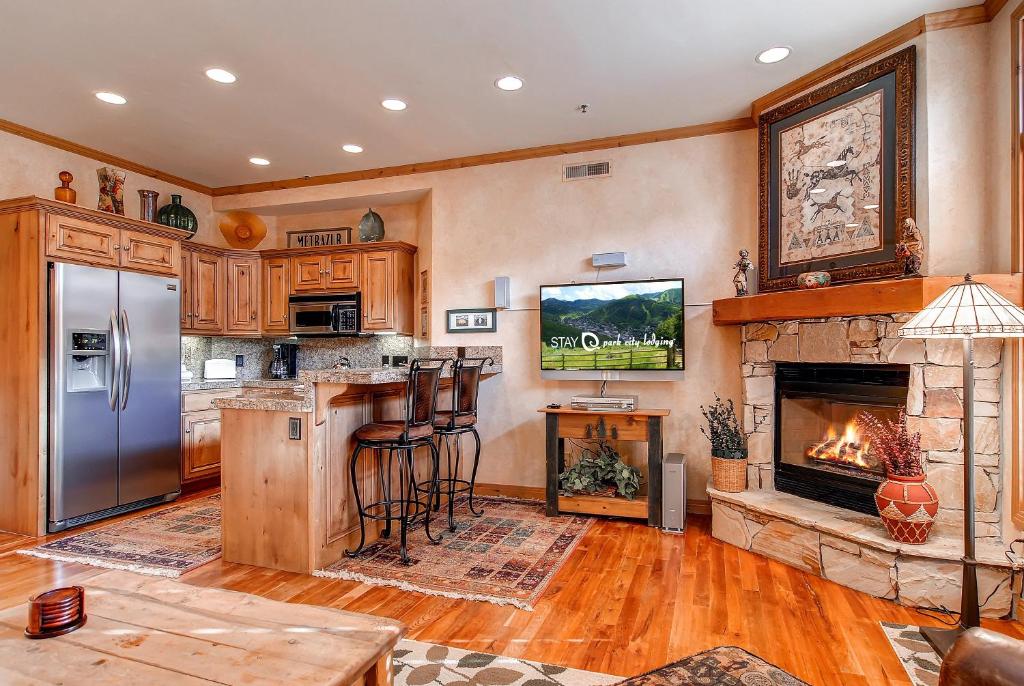 a kitchen with a fireplace and a fire place at LIFT LODGE 203 condo in Park City