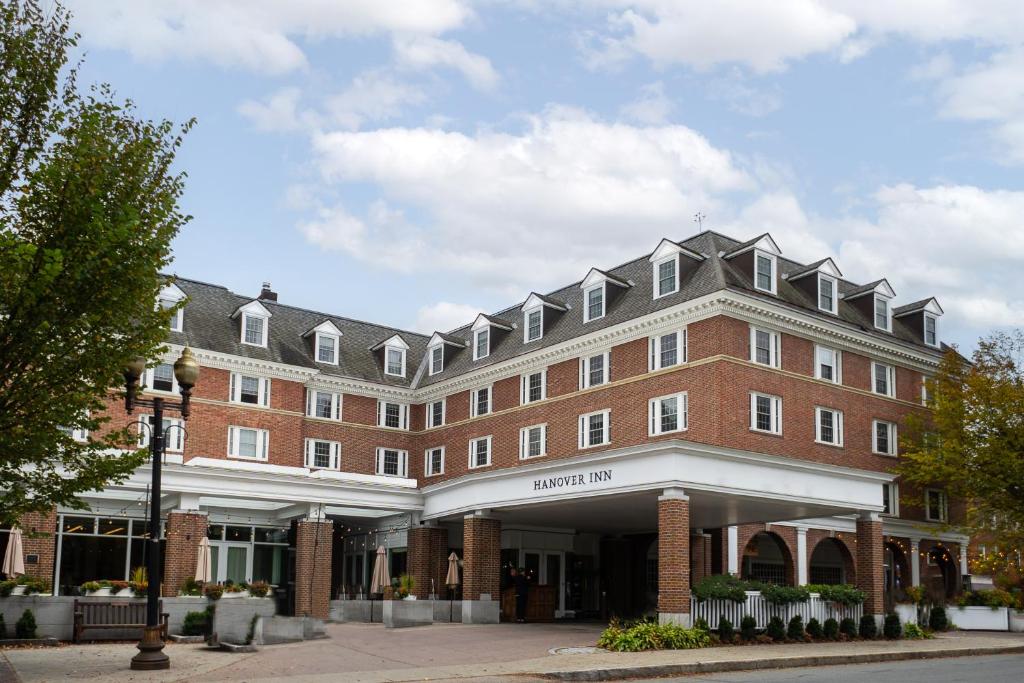 a large red brick building on a street at Hanover Inn Dartmouth in Hanover