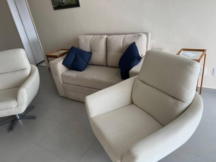 a living room with a couch and a chair at Está errado! App ruim in Rio de Janeiro