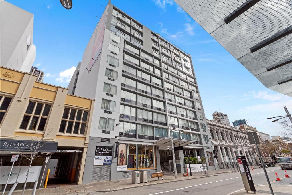 a tall building on a city street with buildings at Downtown Perth Studio On Murray Street in Perth