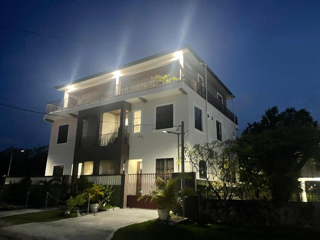 a white house with lights on top of it at Apex boutique apartments in Georgetown